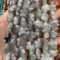 Close-up view of grey natural stone beads in flower shape for DIY jewelry crafting - 25 Pieces/Strand (15x15x5mm) / Labradorite