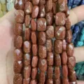 Macro detail of faceted rectangular brown goldstone beads for DIY jewelry craft projects. - Gold Sandstone