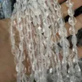 Close-up macro view of faceted clear crystal teardrop beads for DIY jewelry and craft making - White Crystal