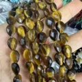 Close-up detail of faceted tiger eye drop beads for natural stone DIY jewelry design - Tiger Eye