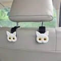 Close-up detail shot of cute cat car headrest hook installed on seat pole for interior storage. - Style 2 / 1 Piece/Pack