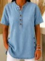 Detail view of women's short sleeve denim tunic shirt with front button placket and side split. - S / Light Blue
