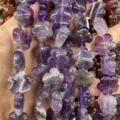 Macro detail of purple amethyst flower-shaped loose beads for jewelry making - 25 Pieces/Strand (15x15x5mm) / Purple Crystal