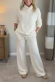 Beige turtleneck top and pants detail, showing soft fabric texture, cozy knit and style. - White