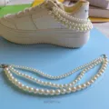 Closeup of multi-layer pearl chain shoe accessory showing detailed bead size and length. - 1 Piece