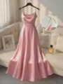 Detail view of pink satin slip dress with pearl beaded straps, elegant event apparel close-up. - Pink
