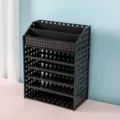 Black plastic desktop organizer with multi-tier grid design for storing cosmetics securely. - Black