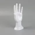 White glossy mannequin hand jewelry display stand for showcasing rings bracelets and gloves. - White