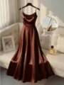 Closeup of elegant brown satin dress with pearl beaded straps, detail shot in luxury room setting. - S / Dresses / Coffee