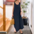 Detailed view of a stylish sleeveless linen long dress worn by model in an indoor setting. - S / Dresses / Navy Blue