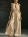 Elegant beige halter neck sleeveless wide leg jumpsuit showcasing chic summer style - Apricot
