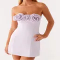 Detailed view of the light purple strapless mini dress featuring 3d flower accents. - Violet