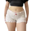 Vista detallada de pantalones cortos de tiro bajo fruncidos con lazo rojo y lindo estampado. - S / Marfil