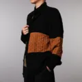 Close-up view of the men's color-block knit cardigan showing textured brown chest panel. - S / Black