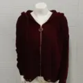 Burgundy knit hooded cardigan detail, featuring metal ring zipper and distressed hem design. - Red