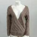 Detailed view of women's V-neck hollow-out knit sweater texture and long sleeve design. - S / Brown