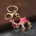 Detailed view of a metal camel keychain with pink enamel and rhinestones, alloy bag pendant. - Pink