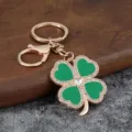 Fashionable gold-plated four-leaf clover keychain with green enamel and sparkling rhinestones. - Green