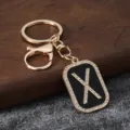 Detail view of the creative gold rhinestone letter X keychain pendant for bag accessory. - Letter X