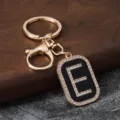 Rhinestone letter E metal keychain pendant, stylish car key ring and bag accessory detail. - Letter E