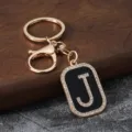 Gold metal letter J rhinestone keychain detail view, stylish bag accessory and key holder. - Letter J
