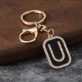Gold metal letter U keychain with rhinestones, black enamel pendant, stylish car bag accessory. - Letter U