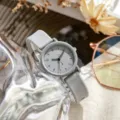Minimalist quartz watch with grey silicone strap, classic round dial detail shot. - Gray