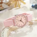 Close-up detail shot of the pink silicone strap quartz watch dial, showing clear numbers. - Pink
