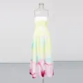 Primer plano detallado del vestido largo sin tirantes amarillo degradado con dobladillo floral. - S / Amarillo
