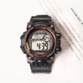 Detailed view of the multi-functional sport digital watch with bold black strap and orange bezel. - Black