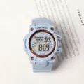 Detailed close-up of light blue sport digital watch, durable and casual style design. - Blue