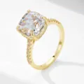Close-up detail of cushion cut cubic zirconia ring with pavé band in gold finish. - Yellow Gold Main Ring