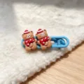 Close-up of cute Christmas bear hair clip detail, sweet design on blue pin, lovely accessory. - Blue Scarf Bear Hair Clip