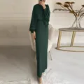Detailed view of the dark green long-sleeve maxi dress with stylish belt in indoor setting. - S / Dark Green
