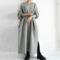 Detail shot of the loose grey sweatshirt dress, showcasing side slit and long sleeves. - S / Silver