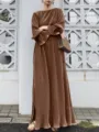 Detailed view of the elegant brown pleated kaftan dress worn by model in outdoor scene. - 2XL / Dresses / Brown