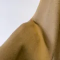 Cashmere wool fabric coat swatch, premium camel color warm winter outerwear material detail. - Camel