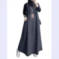 Detailed view of the loose casual denim overall dress featuring convenient front pockets. - Dark Blue