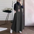 Detailed view of casual loose denim overall dress with big pockets for autumn wear. - Black