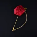 Red satin rose brooch with gold tone long pin and hanging chain detail closeup display - Red