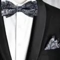 Detailed view of men's black grey paisley bow tie and pocket square set with suit. - Bow Tie + Pocket Square(D2L8061-X) / Black and Gray