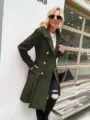Detailed view of women's double breasted wool trench coat in dark green, outdoor scene. - M / Army Green