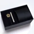 Men's black tie gift set detail showcasing the exquisite texture, elegant tie clip and decorative badge. - KHVA8007-1B