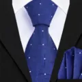 Close-up detail of the blue men's business tie fabric featuring geometric pattern and dots. - Navy Ribbed