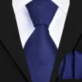 Detail view of navy blue men's business necktie and matching pocket square with geometric pattern. - Dark Blue Irregular Twill