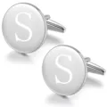 Detailed close-up view of polished silver round metal cufflinks with custom letter S engraving. - Letter S