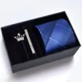 Men's blue plaid tie set with crown brooch and tie clip in a gift box for formal business wear. - KHVA8018-1A