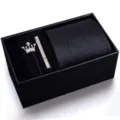 Details of men's black tie gift set featuring striped tie, silver crown brooch and tie clip. - KHVA8041-1A