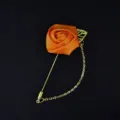 Elegant orange fabric rose lapel pin with metallic chain and leaf, perfect for weddings and events. - Orange
