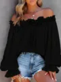 Primo piano dettagliato dell'elegante camicetta nera con maniche lunghe e spalle scoperte. - 1XL / Nero